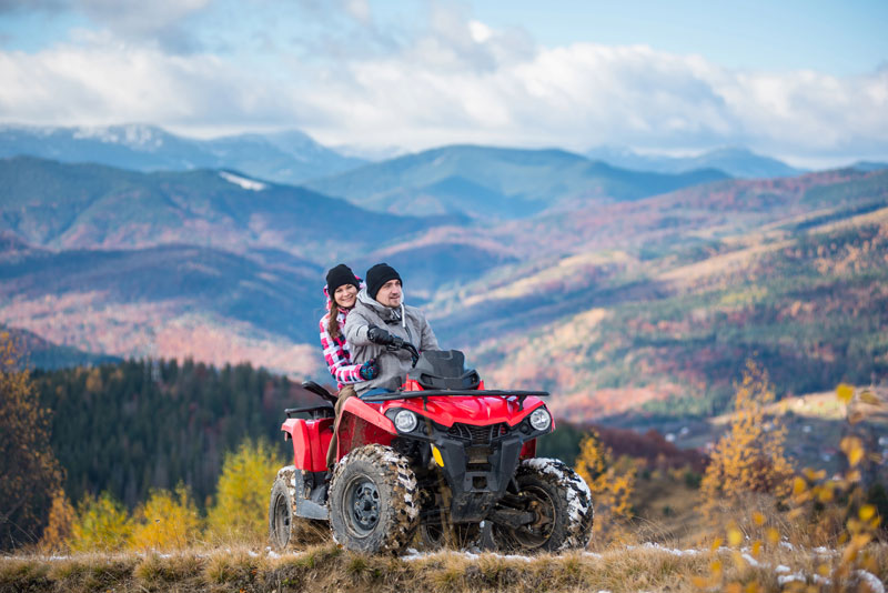 man and woman riding atv